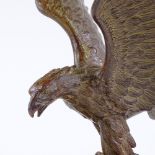 An early 20th century patinated spelter sculpture of an eagle, unsigned, on black marble plinth,