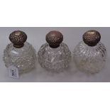 3 Art Nouveau moulded glass scent bottles, with embossed silver tops