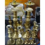 A pair of brass candlesticks on tripod supports, 16", and 5 other pairs