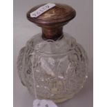 A cut-glass and silver-mounted scent bottle