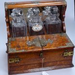 A Victorian oak tantalus with 3 cut-glass decanters, 13.5" across