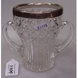 A cut-glass 2-handled vase with silver rim