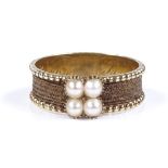 An Antique unmarked gold pearl and hair mourning ring, set with 4 split pearls and woven hair shank,