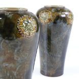 A pair of Royal Doulton green mottled stoneware glazed vases, height 20cm