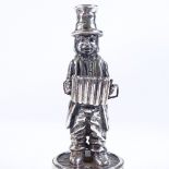 A novelty Spanish silver miniature statue, depicting figure playing a concertina, height 10.5cm, 2.