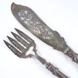 A pair of Victorian silver fish servers, with relief embossed foliate handles and engraved blades,
