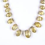 An Antique oval-cut graduated citrine and seed pearl necklace, with unmarked yellow metal clasp,