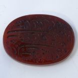 A Middle Eastern oval agate tablet, with inscribed Arabic text and date, length 37mm, 10.1g