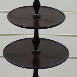 A circular mahogany 3-tier table on tripod base, height 3'2"