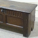 A 17th/18th century joined oak coffer, with carved and panelled front, width 110cm