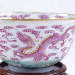 A Chinese porcelain bowl with painted and gilded dragon designs, diameter 11.5cm, A/F