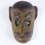 A 19th century Indian carved and painted wood Tribal monkey mask, height 32cm
