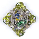An unmarked silver, enamel and pearl George and the Dragon brooch, with pierced scrollwork settings,