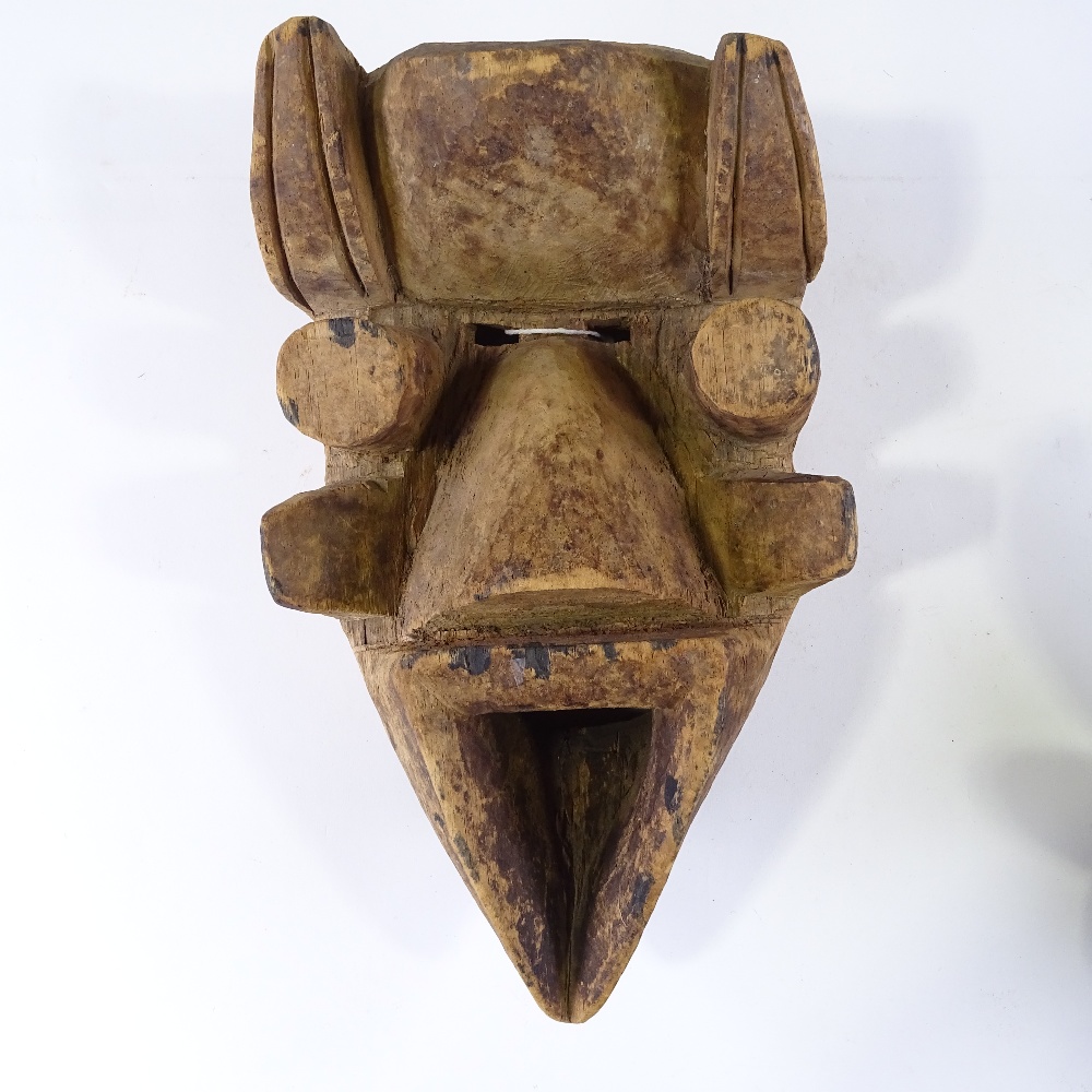 A carved and painted wood African Tribal mask with metal studded decoration, height 34cm, and - Image 2 of 3