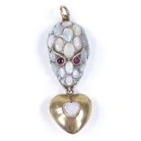 An unmarked gold opal snake head pendant, set with various cabochon opals and red stone eyes,