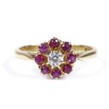 An 18ct gold ruby and diamond cluster flowerhead ring, setting height 9.1mm, size N, 2.9g