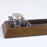 An Asprey's leather-covered desk stand, with original glass inkwells and pen tray with silver