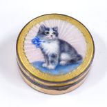 A small circular silver and yellow enamel compact, with kitten design lid and gilt interior,