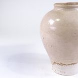 A Chinese Tang dynasty cream glaze pottery storage jar, height 31cm