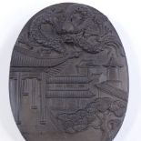 A Chinese relief embossed ink stone with dragon decorated cover, length 14cm