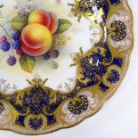 A Royal Worcester porcelain cabinet plate, with hand painted fruit design in textured gilded border,