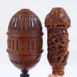 A 19th century carved coquilla nut lidded cup on ivory stand, height 13.5cm, and an ornately