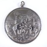 A Continental silver-backed mirror pendant, depicting relief embossed countryside scene, diameter