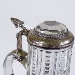 A 19th century cut-glass lidded tankard of small size, with unmarked silver mounts and inset facet-