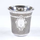 A small French silver thimble-shaped drinking tot, with engine turned decoration and gilt