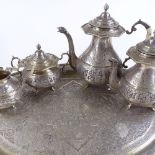 An ornate Middle Eastern 5-piece silver tea set, comprising 2-handled tea tray, hot water jug,