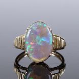 An unmarked gold black opal panel ring, with open-work bridge and ribbed shoulders, unmarked