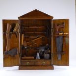 A Victorian panelled oak carpenter's tool cabinet, containing original tools, cabinet height 65cm,