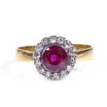 A 22ct gold ruby and diamond cluster flowerhead ring, ruby approx 1ct, setting height 10.7mm, size