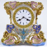 An ornate 19th century French porcelain-cased mantel clock with gilded decoration, enamel dial