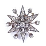 A late 19th century diamond starburst brooch pendant, set with graduated old cushion-cut diamonds,