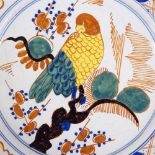 An 18th/19th century Delft tin glazed ceramic plate with painted parrot design, diameter 22cm