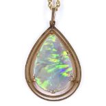 An Edwardian unmarked gold pear-shaped opal panel pendant necklace, on a 9ct chain, pendant height