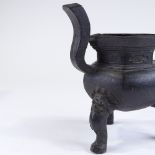 A Chinese patinated bronze incense burner, resting on 3 dragon design feet, overall height 28cm