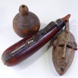 An African carved wood Tribal mask, length 40cm, a beadwork mounted leather gourd, and an elephant
