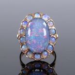An unmarked gold large opal cluster ring, with central opal doublet and pierced under gallery,
