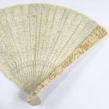 A Chinese 19th century relief carved ivory fan, with fine pierced fretwork ivory screen, length 23cm