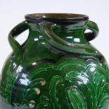 A Brannam Barnstaple Pottery green-glazed vase, with incised scroll decorated panels and 3