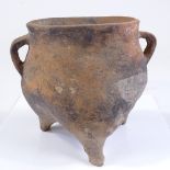 A Chinese Han dynasty terracotta 3-footed cooking vessel, with ring handles, height 20cm, rim