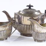A 3-piece silver tea set, of oval half-fluted form, with turned wood mounts, by Stevenson & Law,