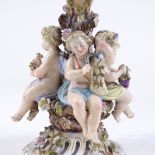 A German porcelain table centre comport, supported by Harvest cherub figures, height 23cm