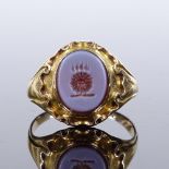 An unmarked gold intaglio agate seal ring, settings test at 18ct gold, setting height 14.3mm, size