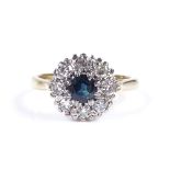 An 18ct gold sapphire and diamond cluster ring, setting height 10.6mm, size I, 3.9g
