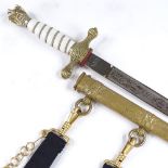 A German Navy dagger with etched blade, engraved brass scabbard and hangers, overall length 41cm