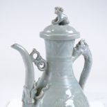 A Qingbai phoenix ewer and cover, Yuan dynasty, with dragon design handle, and panels depicting