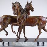 An Art Deco style patinated metal sculpture of 2 horses, on 2-colour marble base, base length 70cm